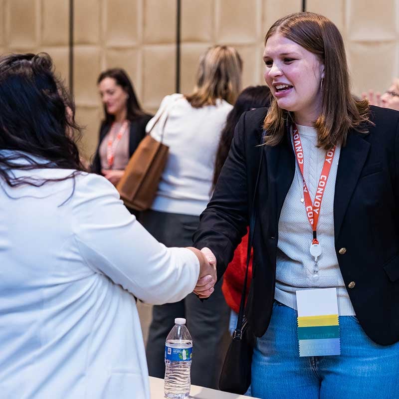 Accelerate-Conference-Attendees-Hand-Shake-800x800