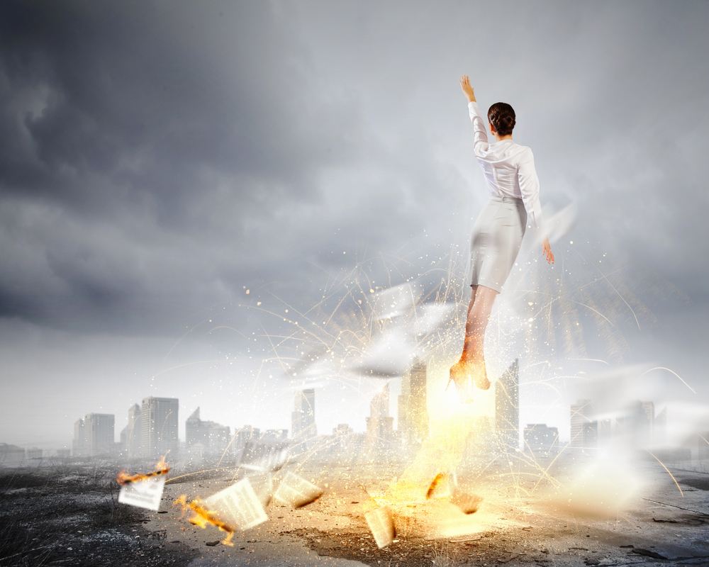 Image of businesswoman flying up into sky