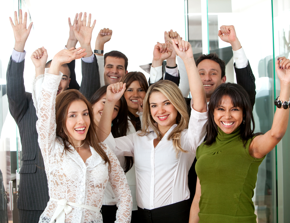 business team in an office full of success looking happy