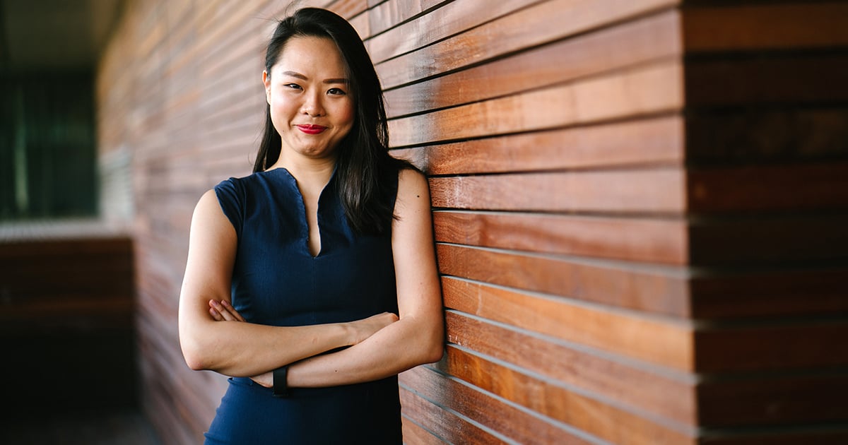 business-woman-posing-on-wall-1200