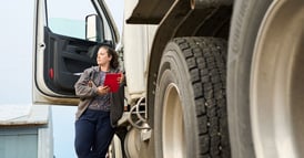 female-driver-standing-outside-truck-1200x628