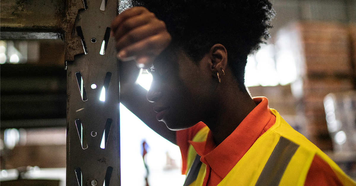 warehouse-worker-leaning-head-on-arm-1200x628