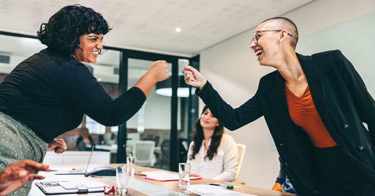 women-fist-bumping-meeting-1200x628