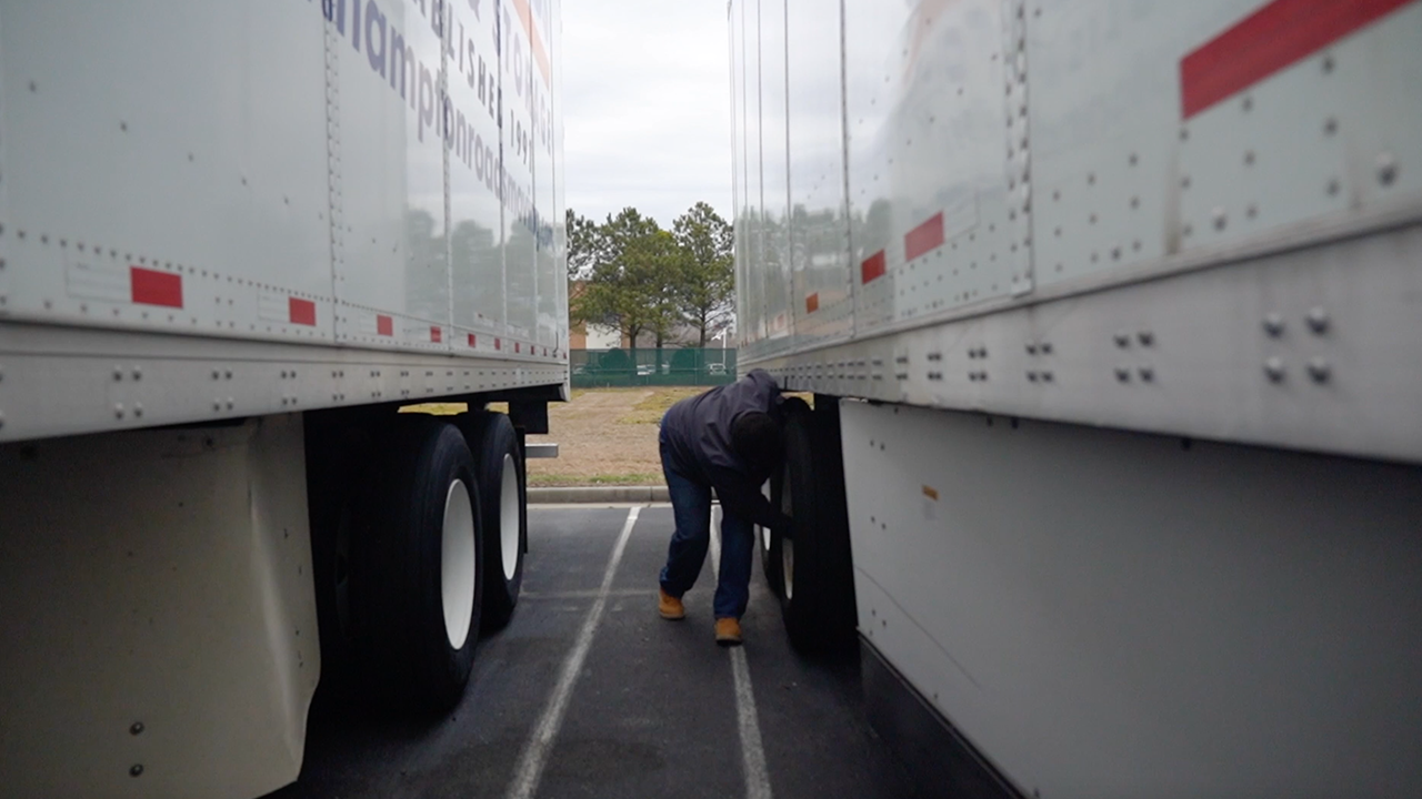 Andrea-Lewis-checking-wheels-truck-1280x720