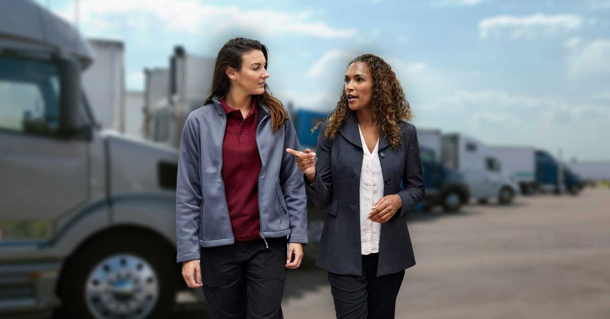 females-walking-in-front-of-trucks-talking-1200x628-WEB